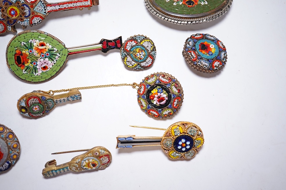 A collection of twenty-five micro-mosaic costume jewellery brooches. Including thirteen banjo and guitars shaped brooches, six large oval and circular brooches and six smaller brooches. Condition - mostly good